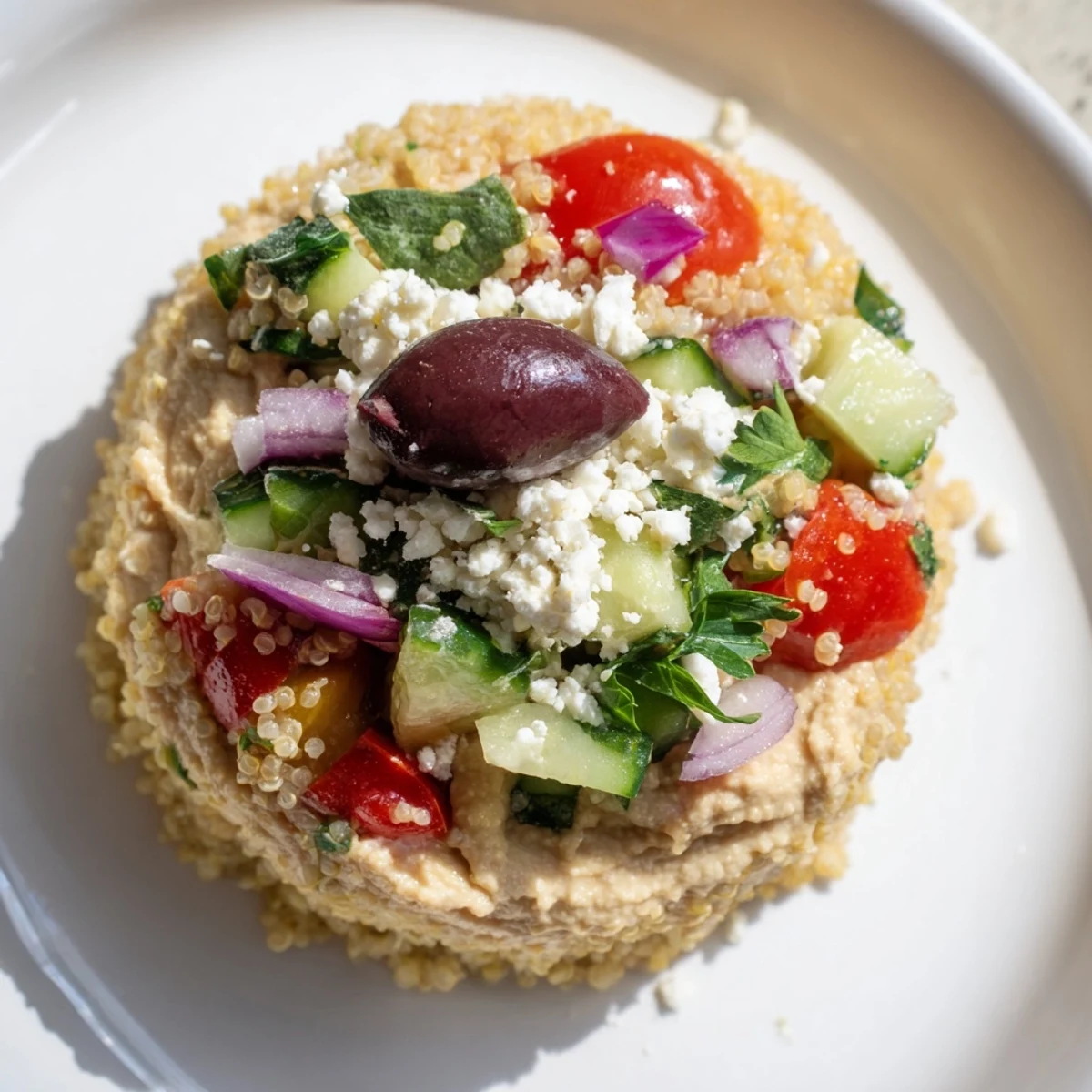 Freshly-made Mediterranean Quinoa Bowl with crumbled feta, ready to serve and enjoy.
