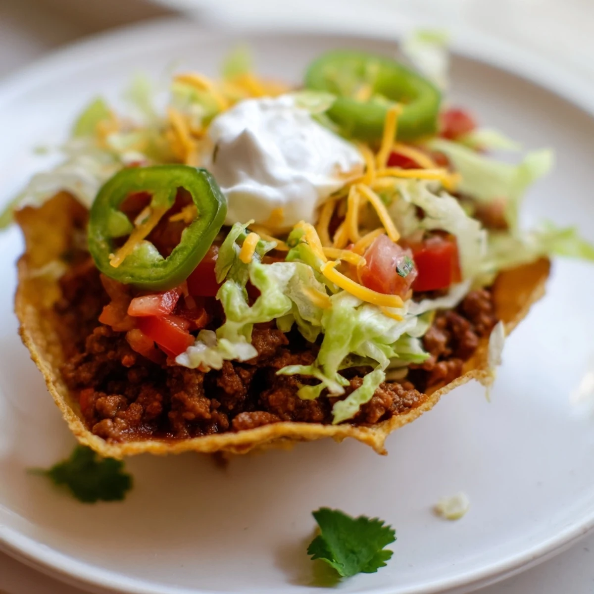 Crispy beef tacos with sour cream, shredded lettuce, tomatoes, and cheddar cheese on a rustic plate.
