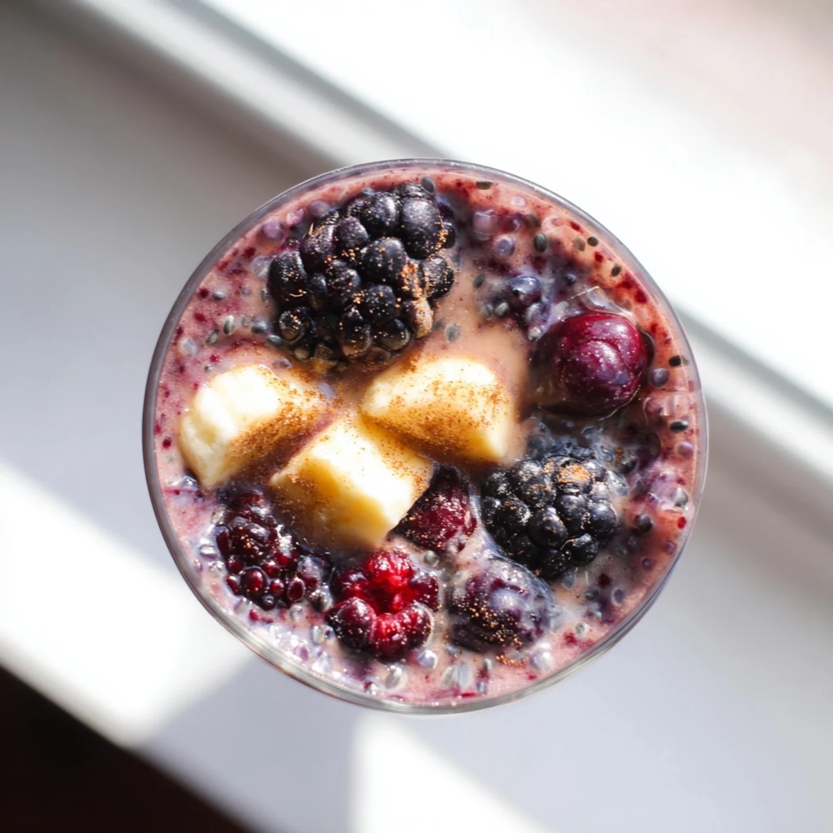 Winter Berry Smoothie with Spinach garnished with a cinnamon stick, ready to serve for a healthy breakfast.