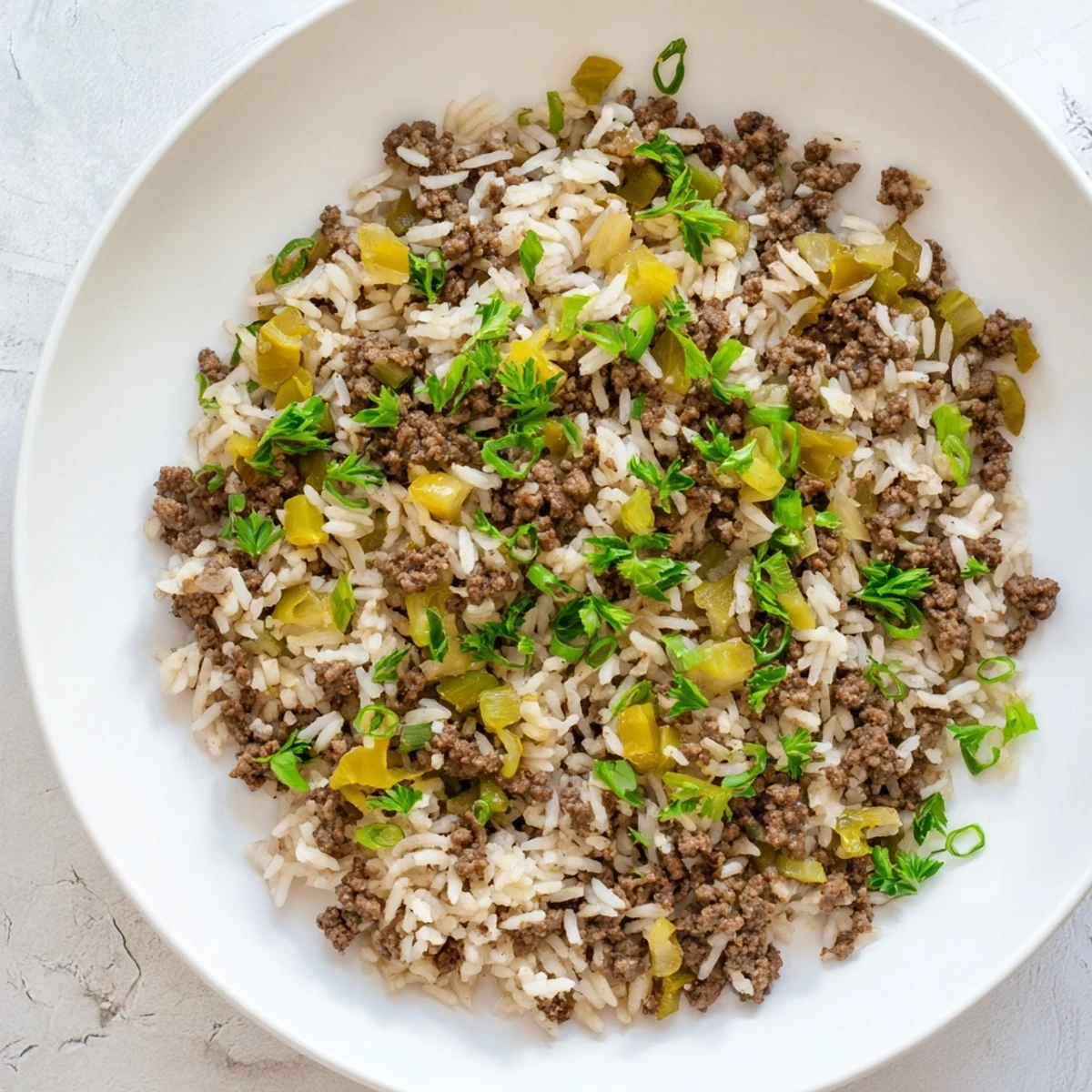 Close-up view of Cajun Dirty Rice with Ground Beef, featuring sautéed peppers, celery, and spiced meat.