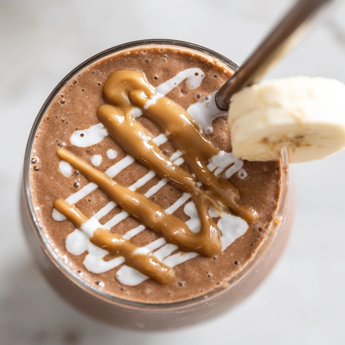 Rich Chocolate Peanut Butter Smoothie with Banana poured into a tall glass, ready for a healthy breakfast or snack.