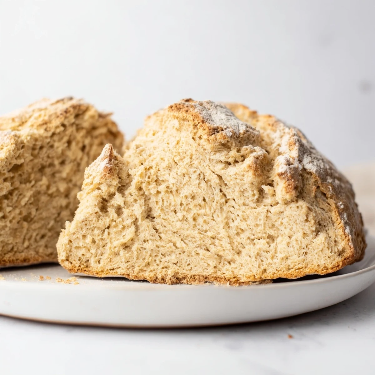 Rustic Authentic 4-Ingredient Irish Soda Bread loaf with a deep X cut on top. 