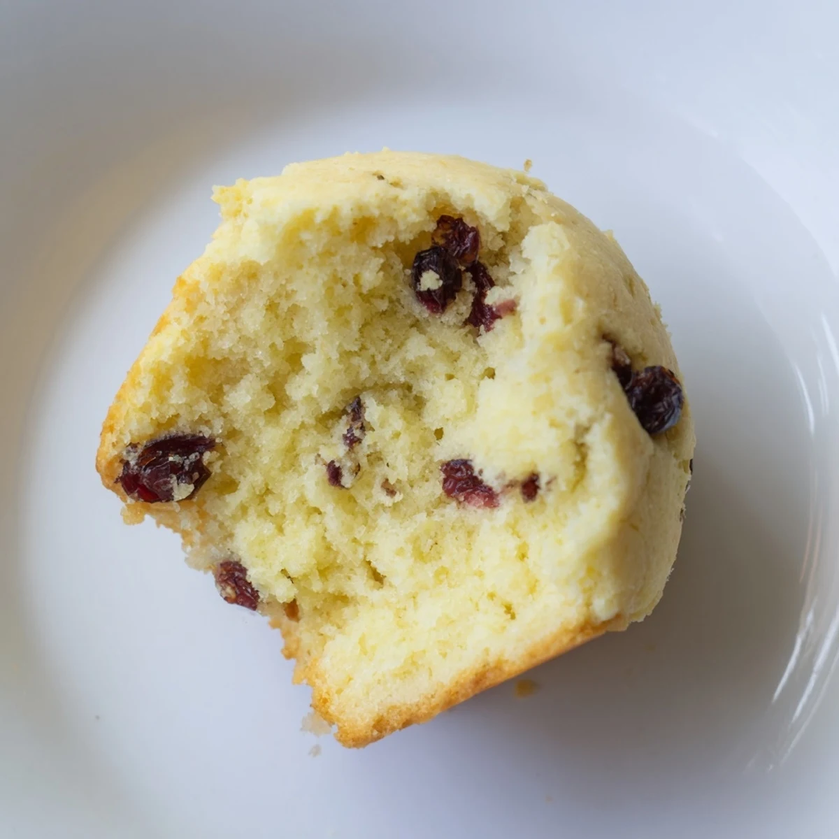 Overhead view of Mini Irish Soda Bread Muffins baked in a mini muffin tin, showing the golden tops and speckled currants.