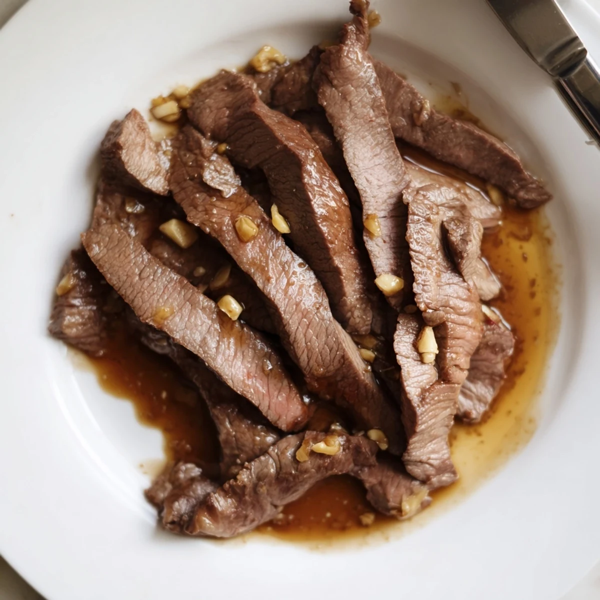 Ultimate Slow Cooker Mongolian Beef plated with broccoli, showcasing fork-tender beef in a rich glaze.
