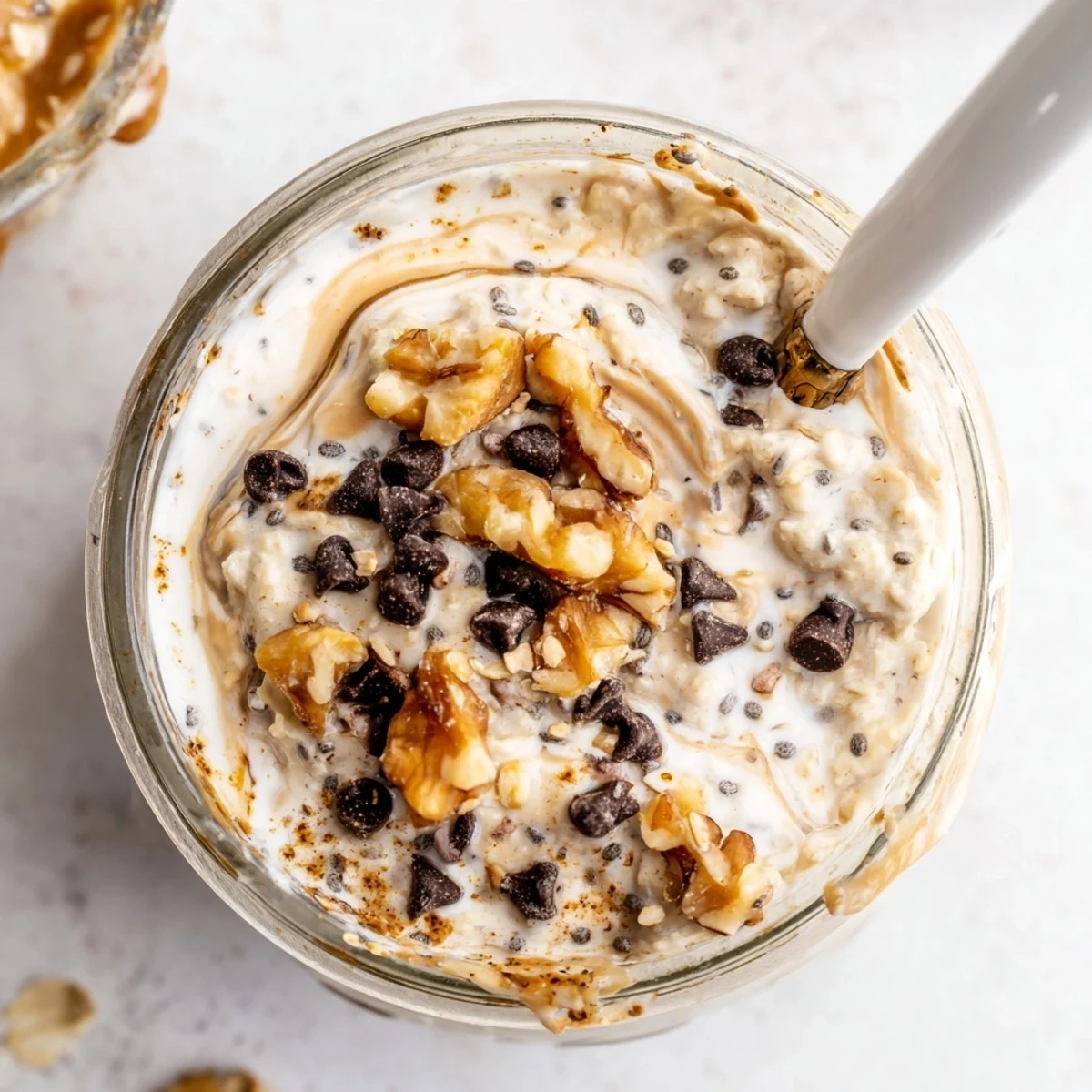 Cookie Dough Overnight Oats topped with almond butter swirls and extra mini chocolate chips for breakfast.