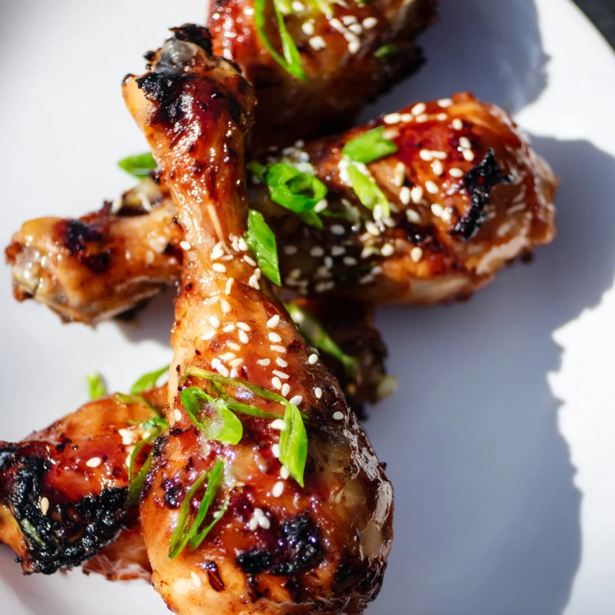 Golden honey garlic baked chicken drumsticks coated in sticky caramelized glaze