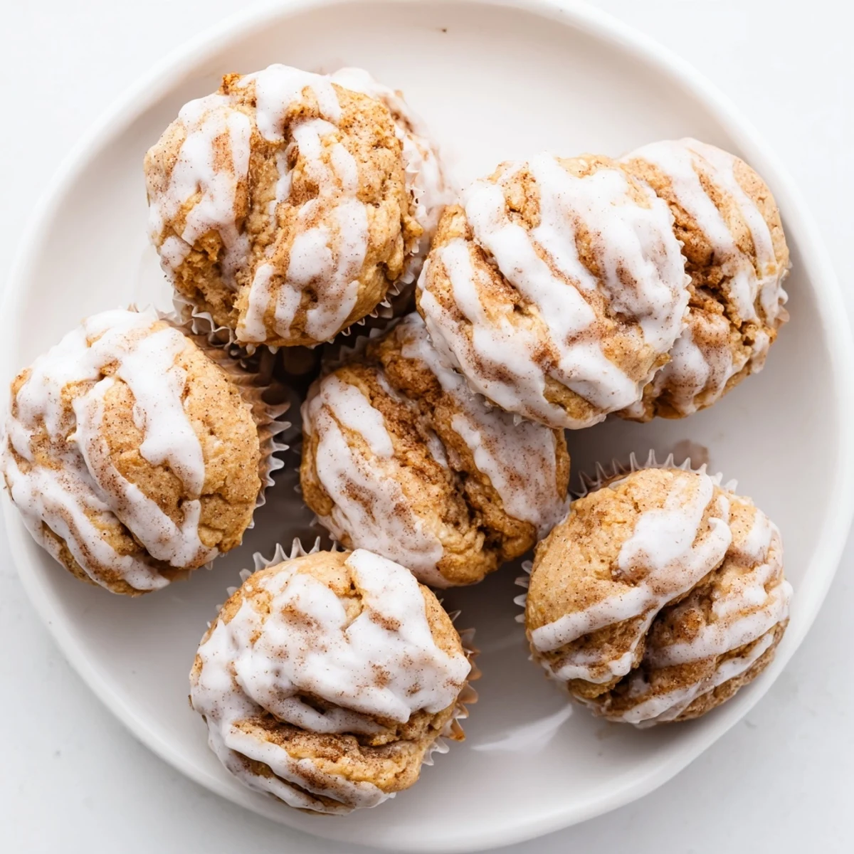 Healthy cinnamon roll protein muffins freshly baked with golden brown tops and cinnamon filling