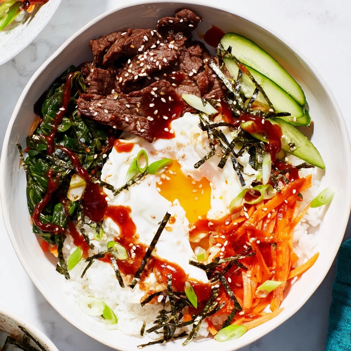 Korean-Inspired Breakfast Bowl featuring marinated beef, fresh vegetables, and sunny-side up egg over fluffy white rice