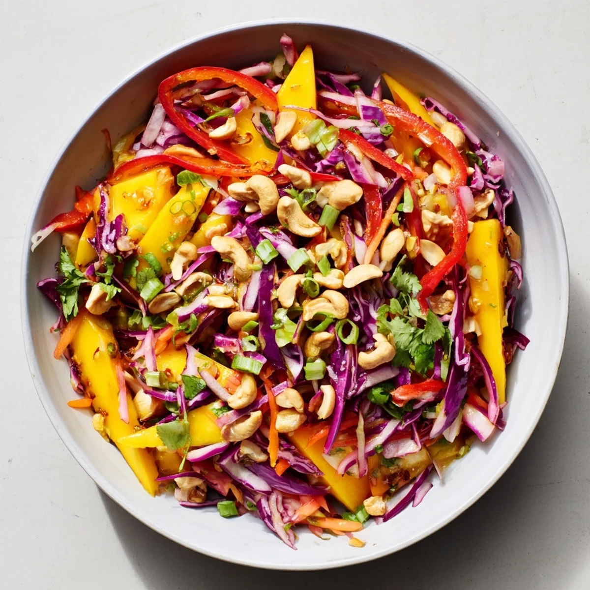 Fresh mango slaw with crisp red cabbage, carrots, and tangy lime dressing