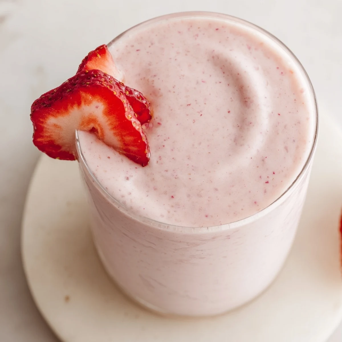 Refreshing strawberry smoothie with Greek yogurt served chilled with optional chia seed topping