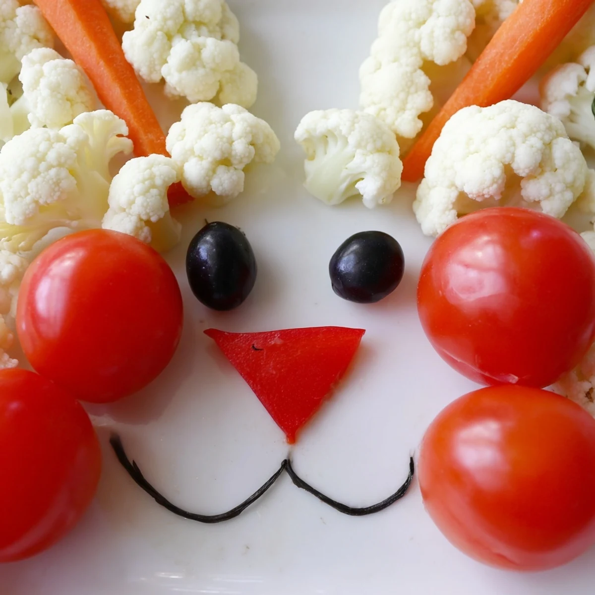 Creative vegetable platter shaped like a bunny featuring crisp carrots, bell peppers, and ranch dip