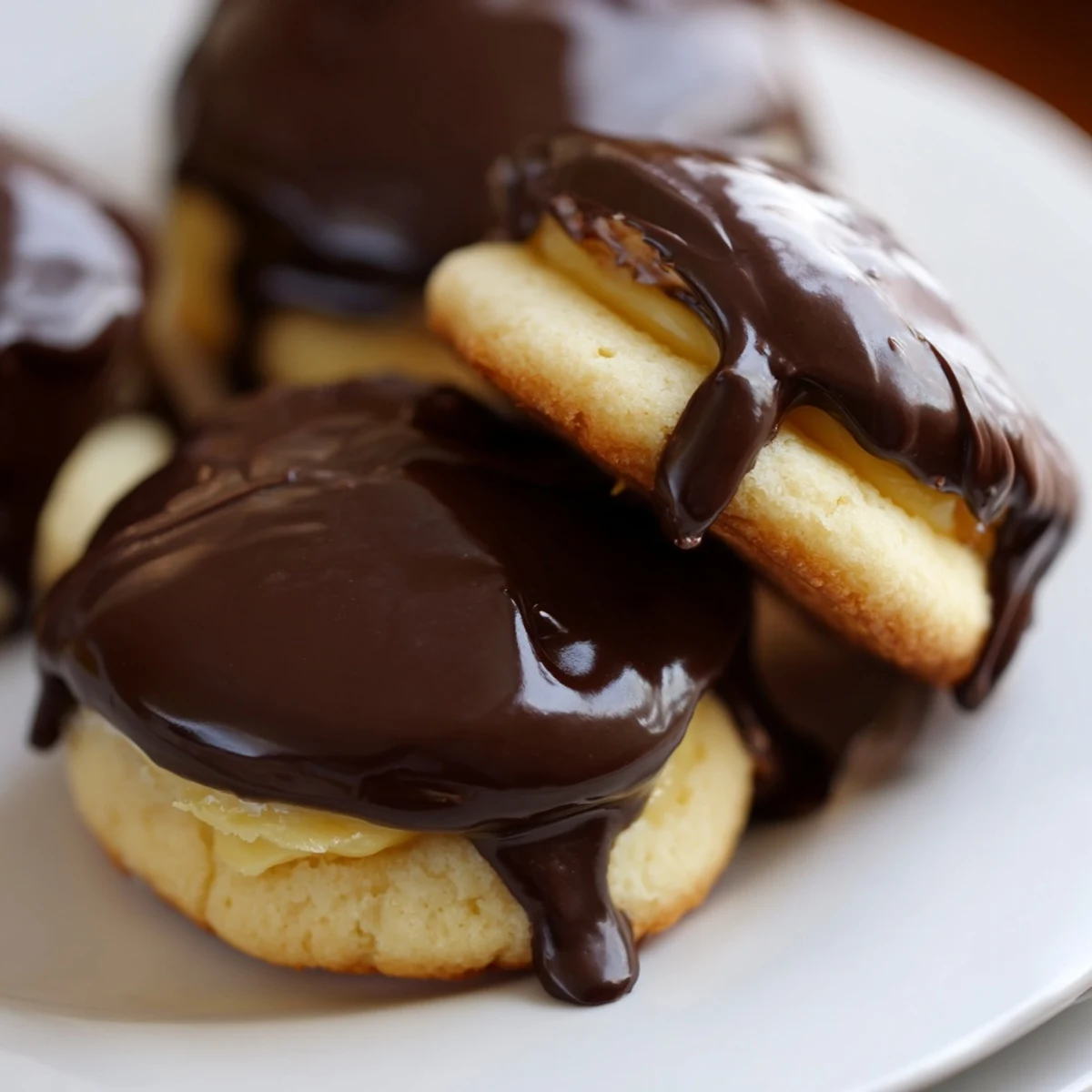 Soft vanilla sandwich cookies filled with creamy vanilla custard and coated in rich chocolate topping