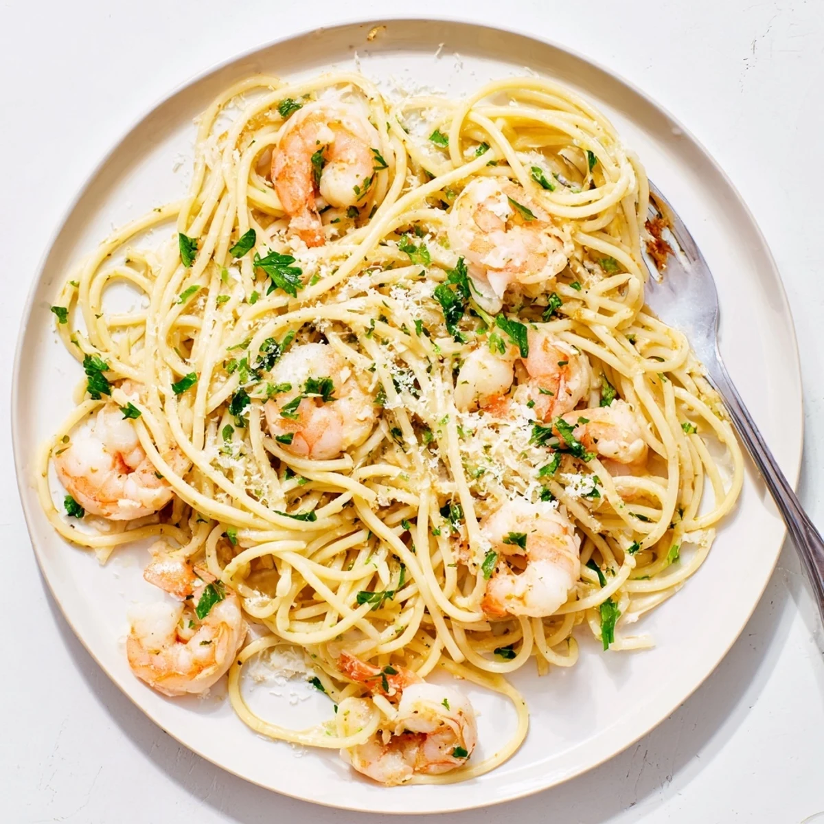Twisted spaghetti noodles tossed with succulent pink shrimp in white wine garlic butter sauce