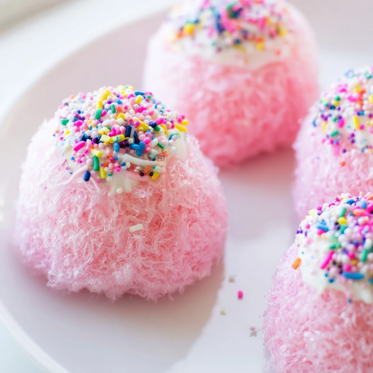 Mini Cotton Candy Cheesecake Puff Balls with fluffy pink coating and creamy centers on a serving plate