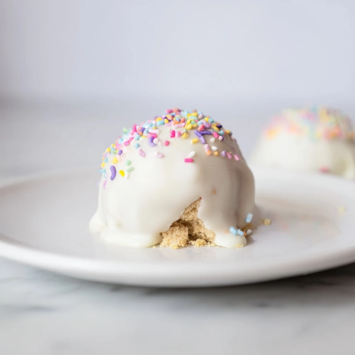 Creamy banana pudding Easter truffles coated in white chocolate with colorful festive sprinkles