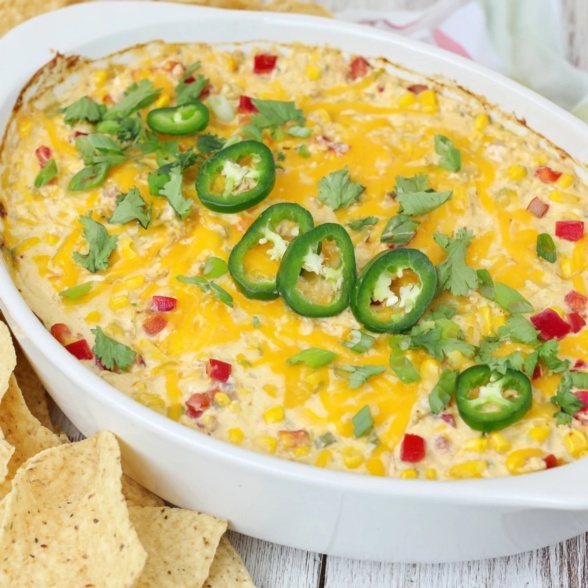 Golden baked spicy roasted jalapeno cowboy cream cheese dip served with crispy tortilla chips