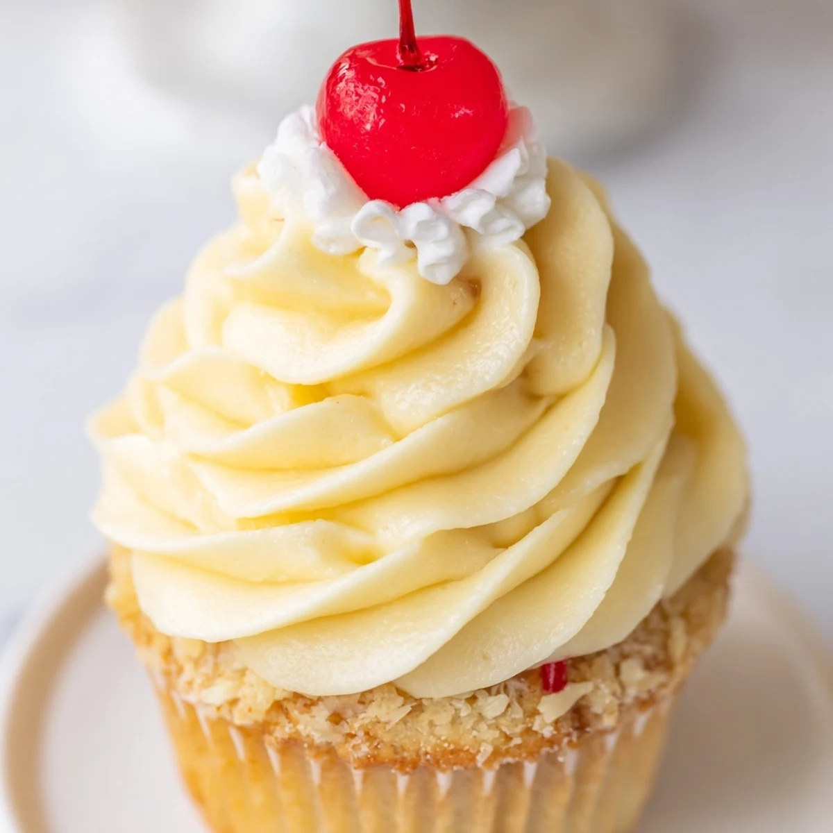 Moist banana milkshake cupcakes with creamy swirled frosting served in decorative paper liners