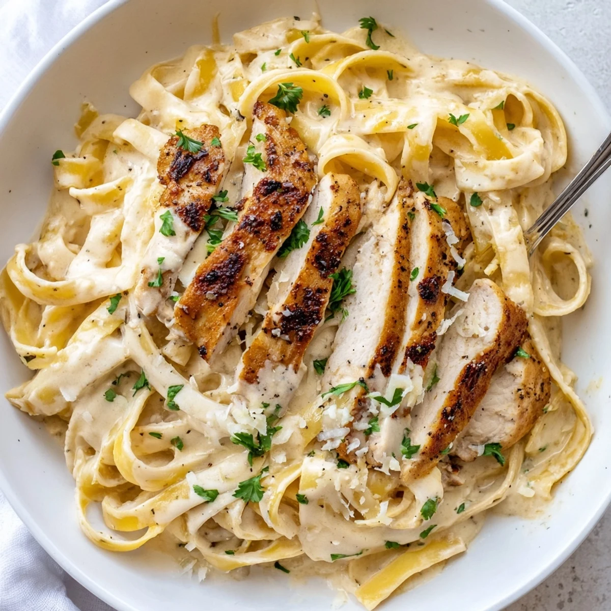 A bowl of Creamy Garlic Chicken Pasta tossed in silky Parmesan cream