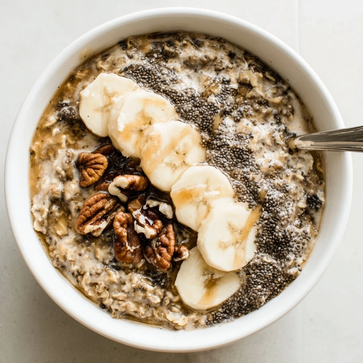 Creamy Brown Sugar Coffee Overnight Oats topped with sliced banana and toasted pecans