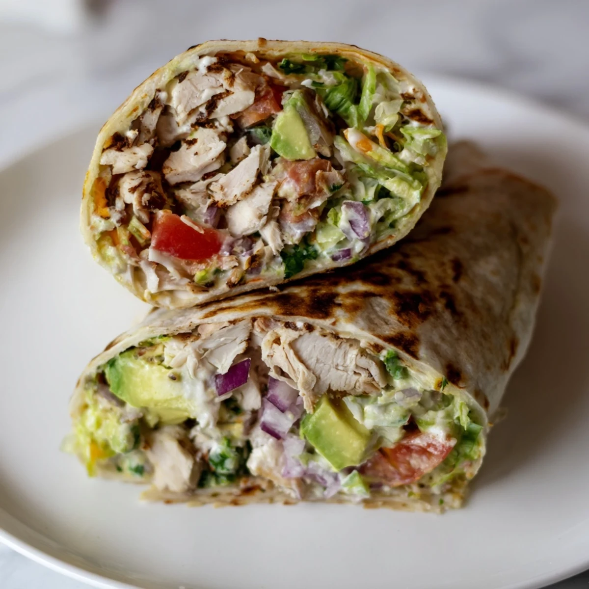 Chicken Avocado Ranch Burritos sliced, showing creamy avocado, juicy chicken, melted cheese