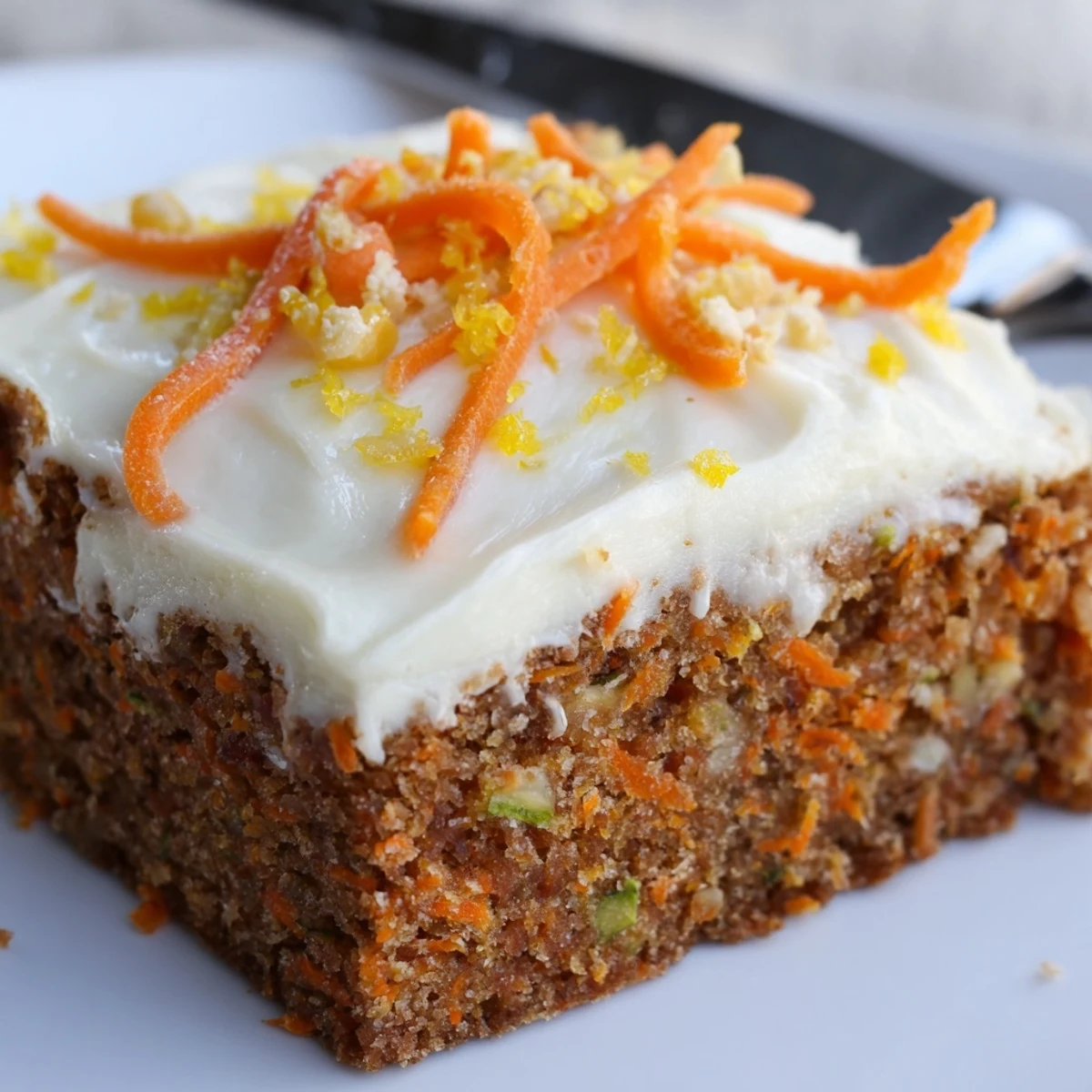 Warm Spiced Ginger Carrot And Zucchini Bars With Lemon Cream Cheese Frosting on plate