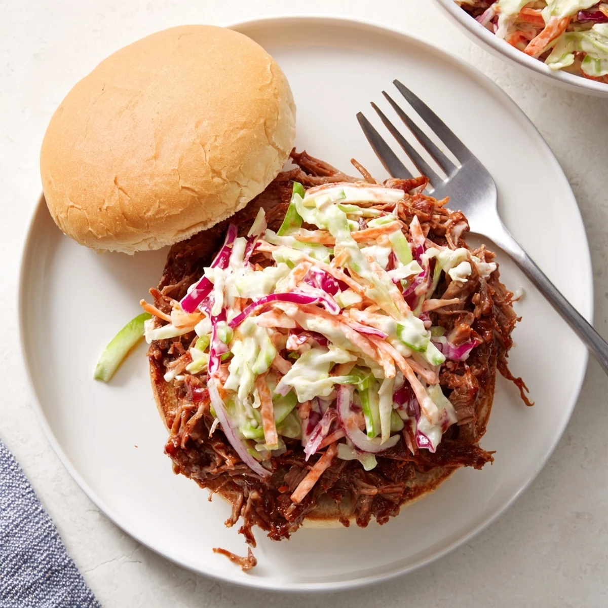 Hearty beef sandwiches loaded with smoky pulled meat and fresh creamy coleslaw topping