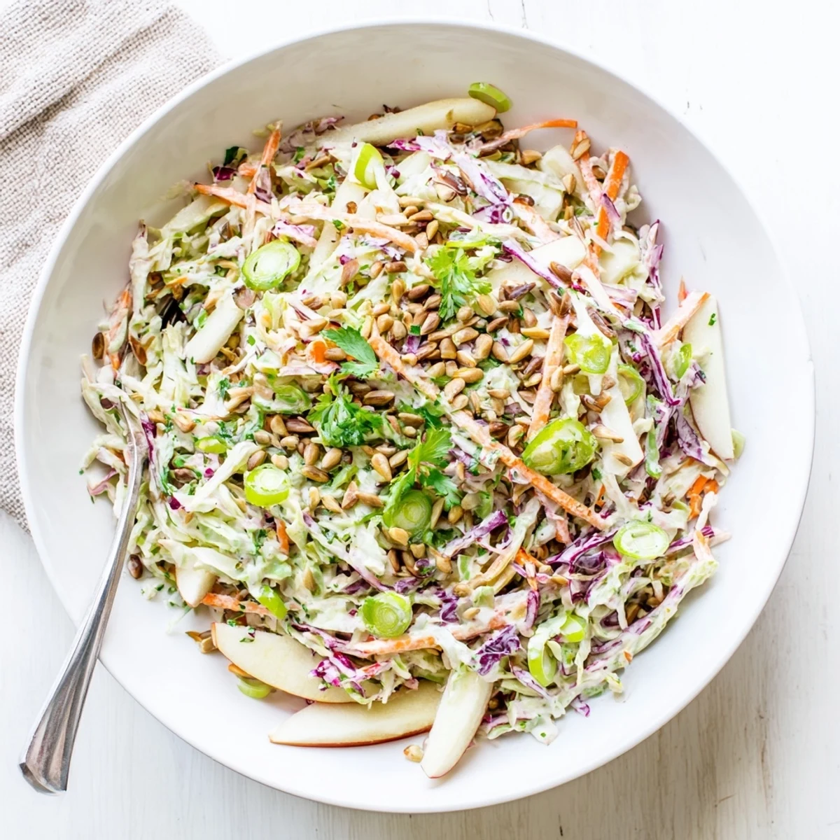 Fresh homemade apple coleslaw featuring crunchy apples and tangy honey-mustard dressing