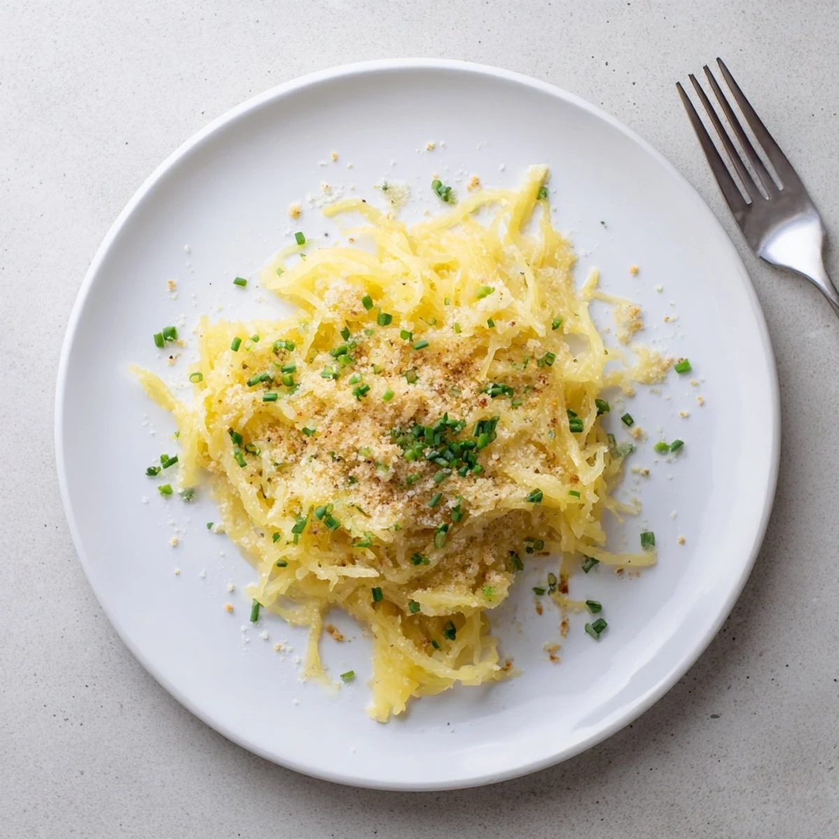 Golden baked spaghetti squash mac and cheese topped with crispy breadcrumbs and fresh chives