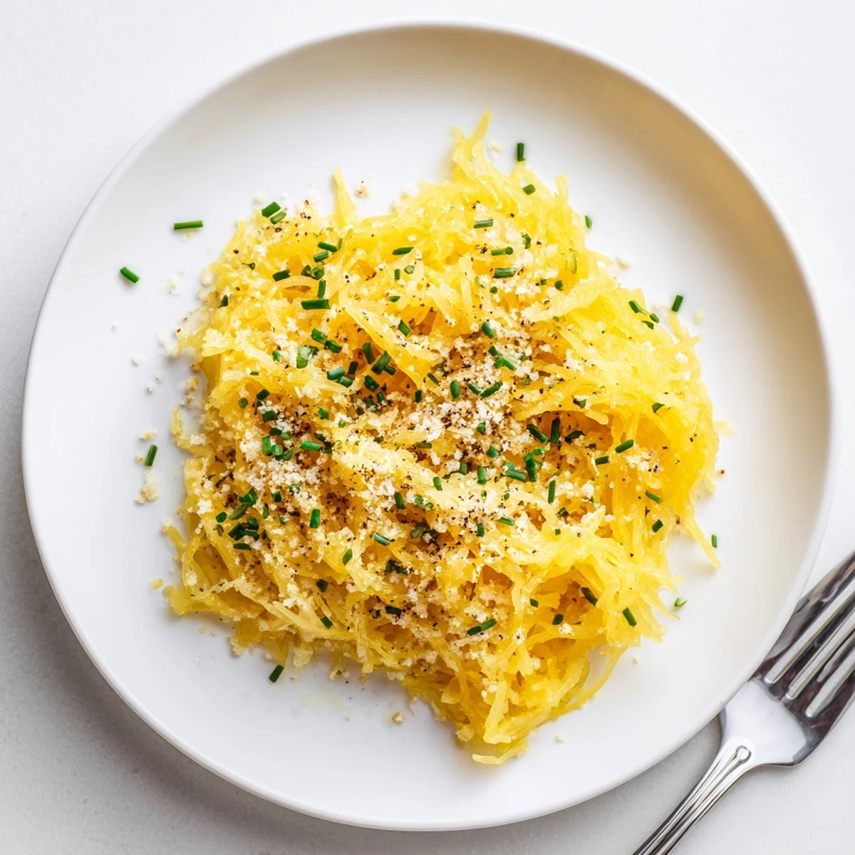 Comforting bowl of spaghetti squash mac and cheese with rich melted cheddar and golden breadcrumb crust