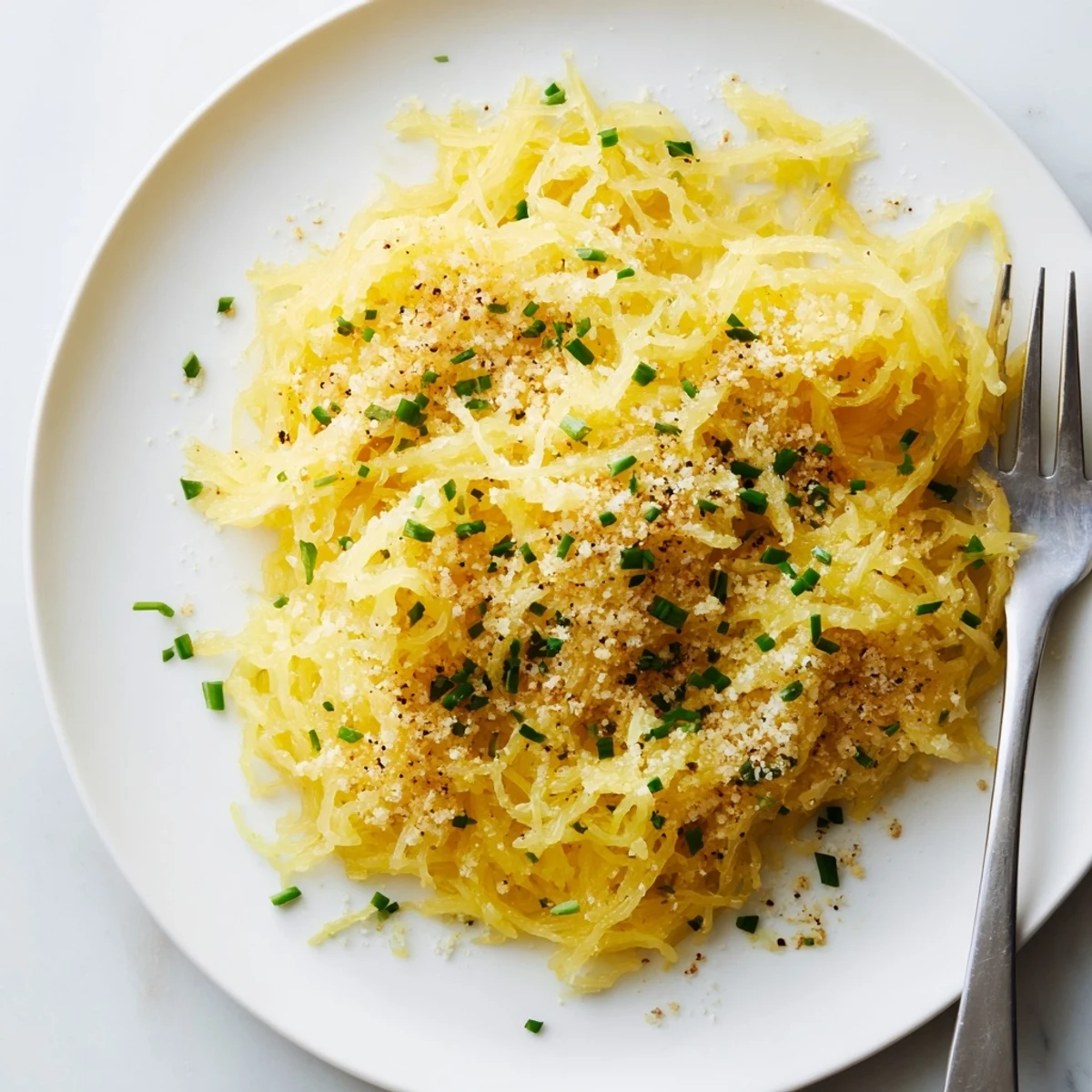 Creamy cheese sauce coats tender roasted spaghetti squash strands in this low carb mac and cheese