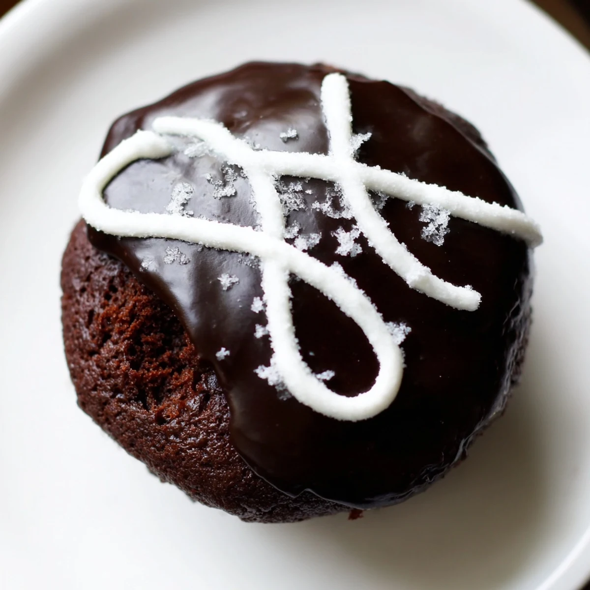 Homemade Hostess Cupcakes with glossy chocolate ganache and signature white icing swirl