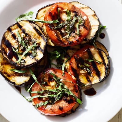 Tender charred eggplant and juicy grilled tomatoes drizzled with balsamic glaze